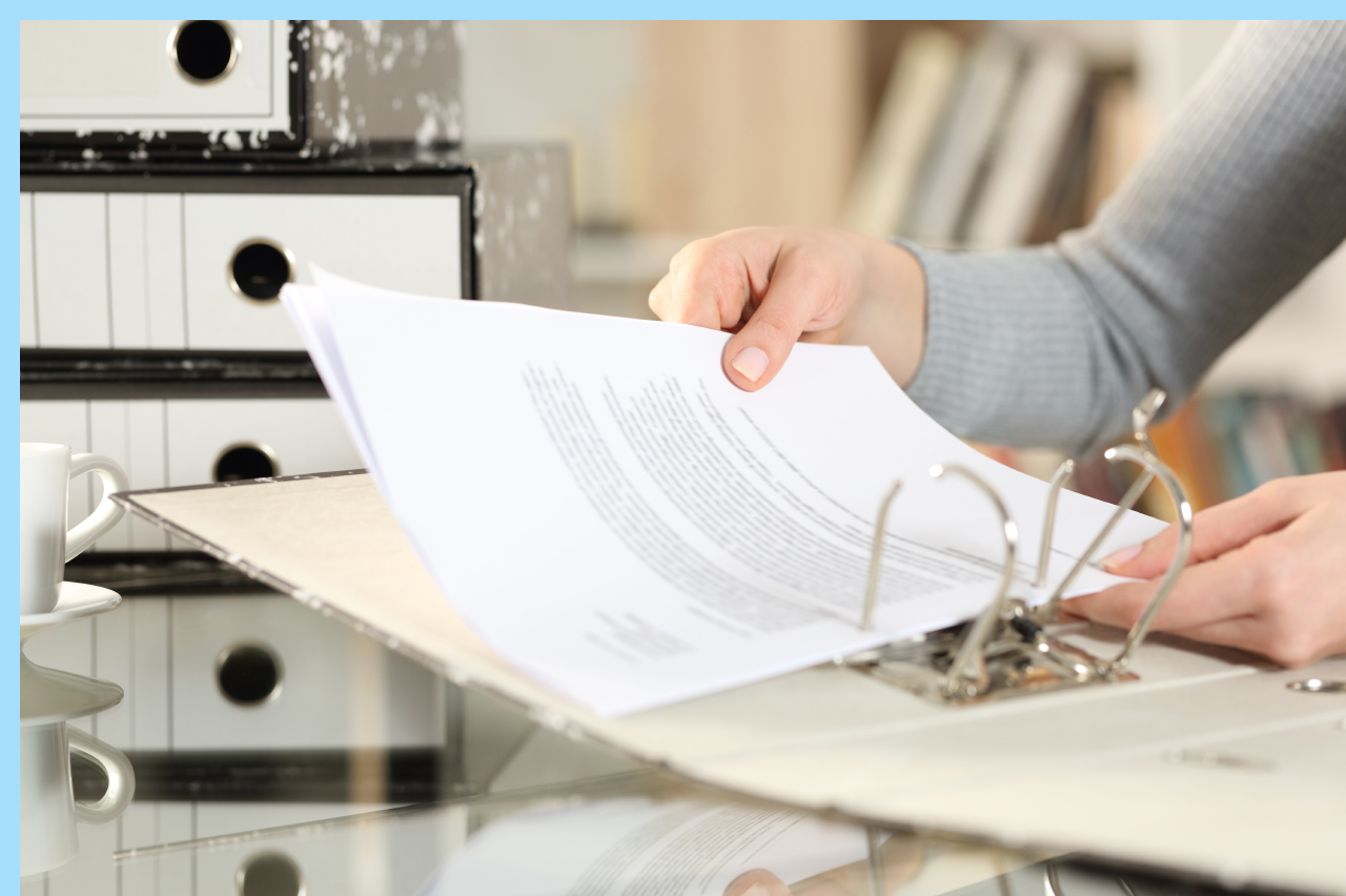 person filing papers in a binder