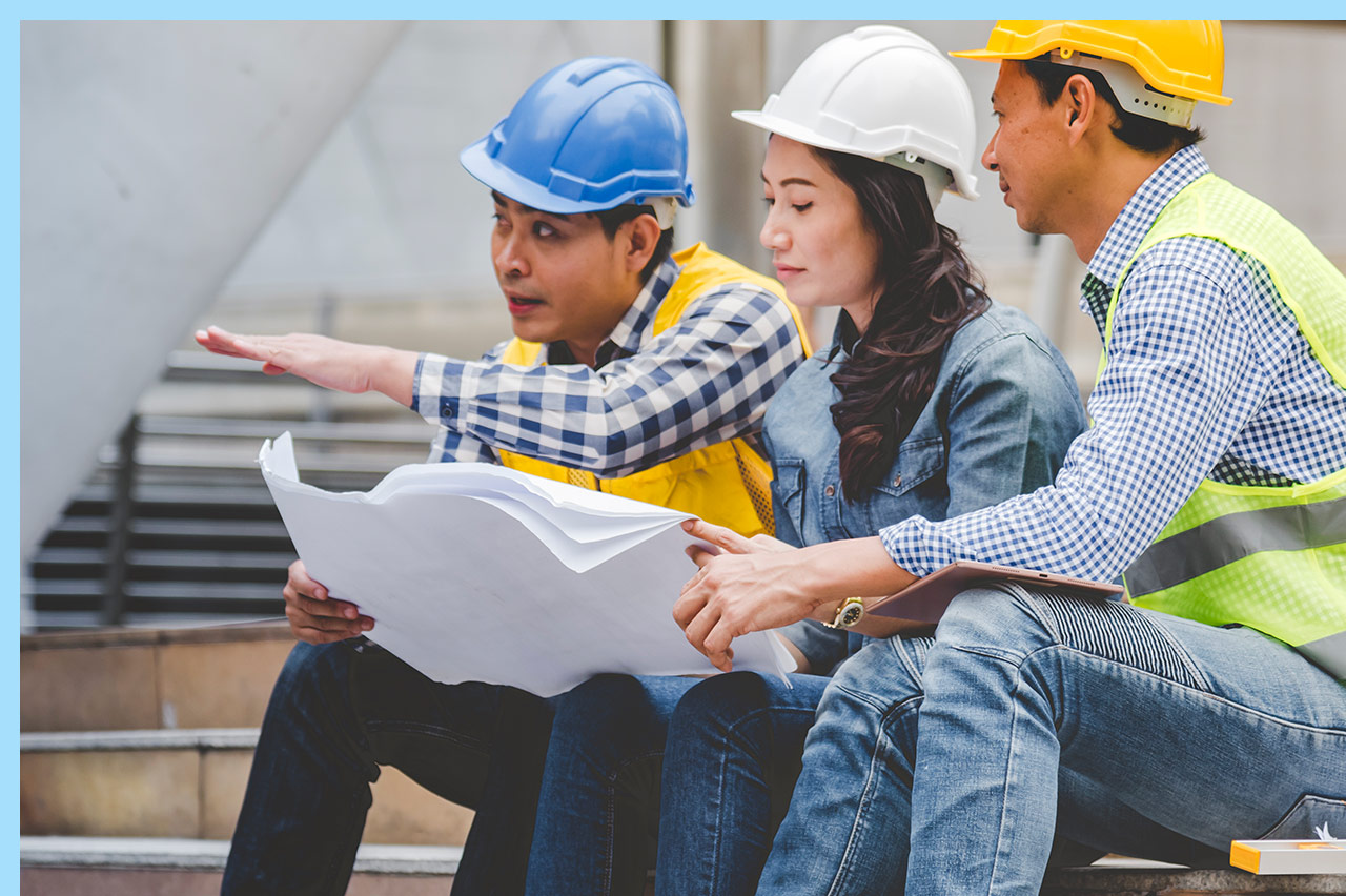 group of construction workers reviewing plans